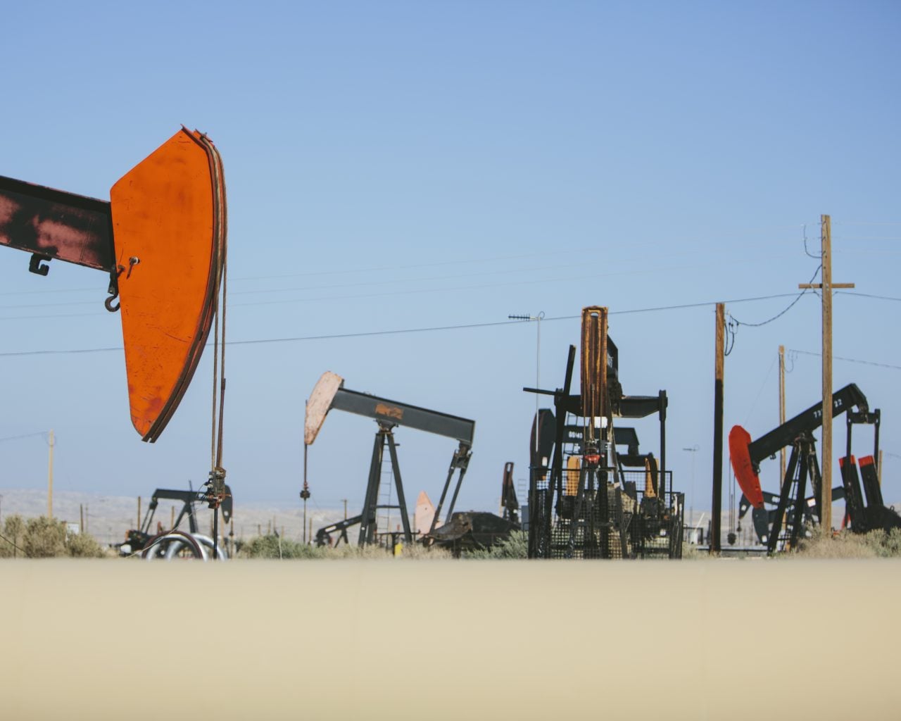 Pump jacks extracting oil in a desert field — CheMost oilfield and drilling chemicals